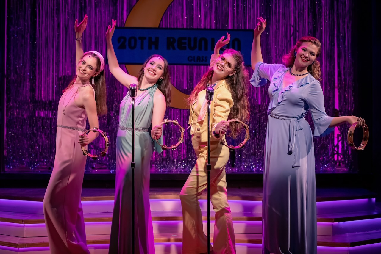 Production still from The Marvelous Wonderettes: Dream On emphasizing the gym architecture and stage composition, scenic design by Brandon PT Davis.