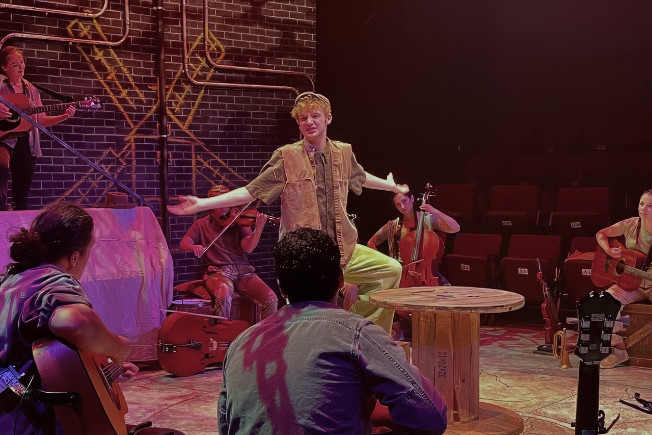 Production image from The Man of La Mancha with industrial textures and modular scenic structure visible, scenic design by Brandon PT Davis.