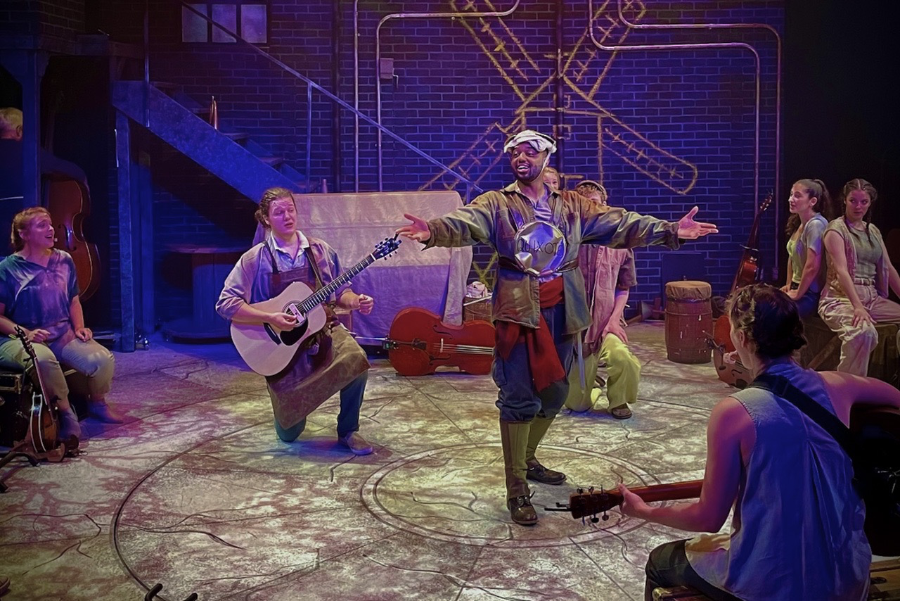 Production image from The Man of La Mancha showing the warehouse-inspired playing space, scenic design by Brandon PT Davis.