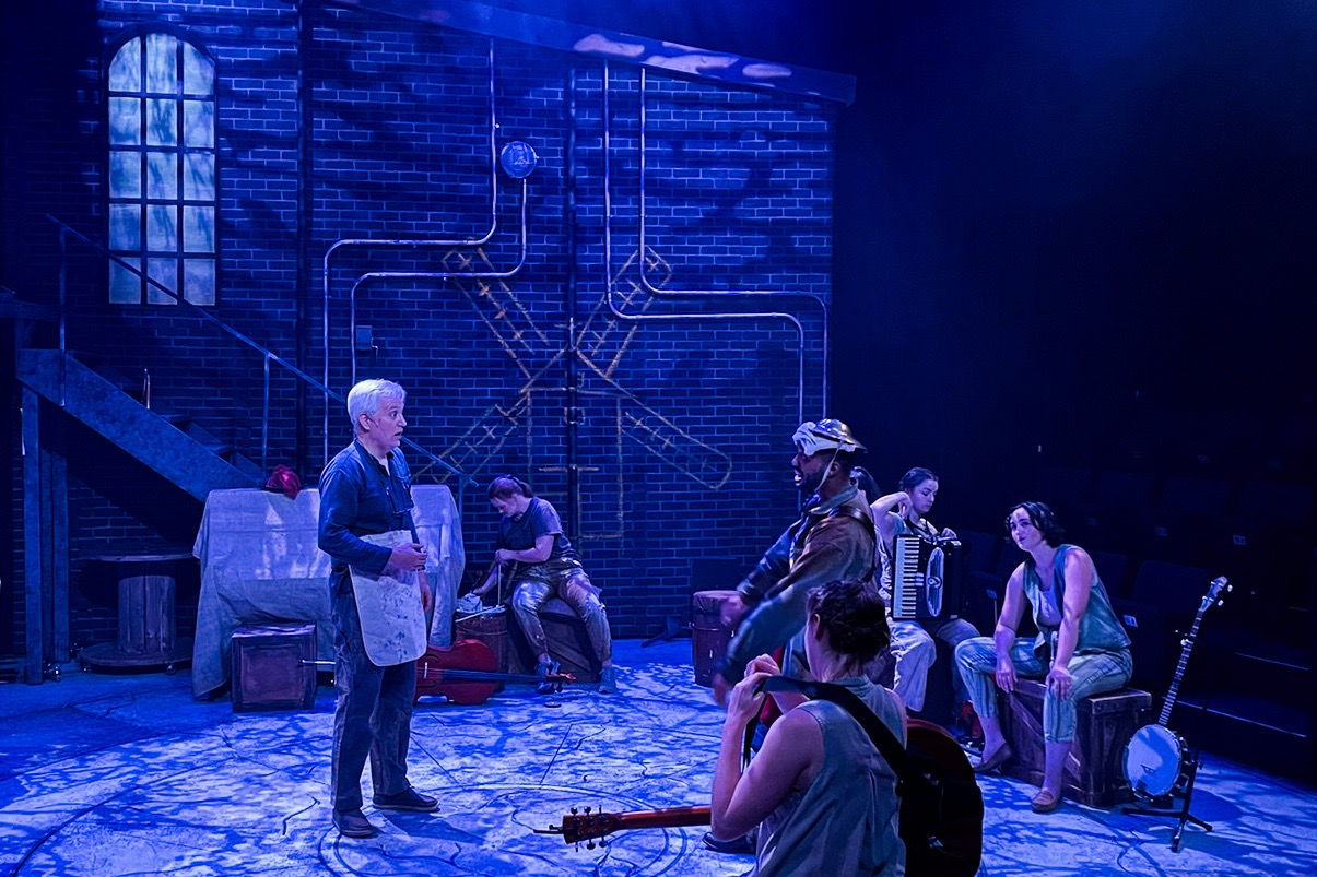 Production still from The Man of La Mancha with actors and musicians inhabiting the scenic world, scenic design by Brandon PT Davis.