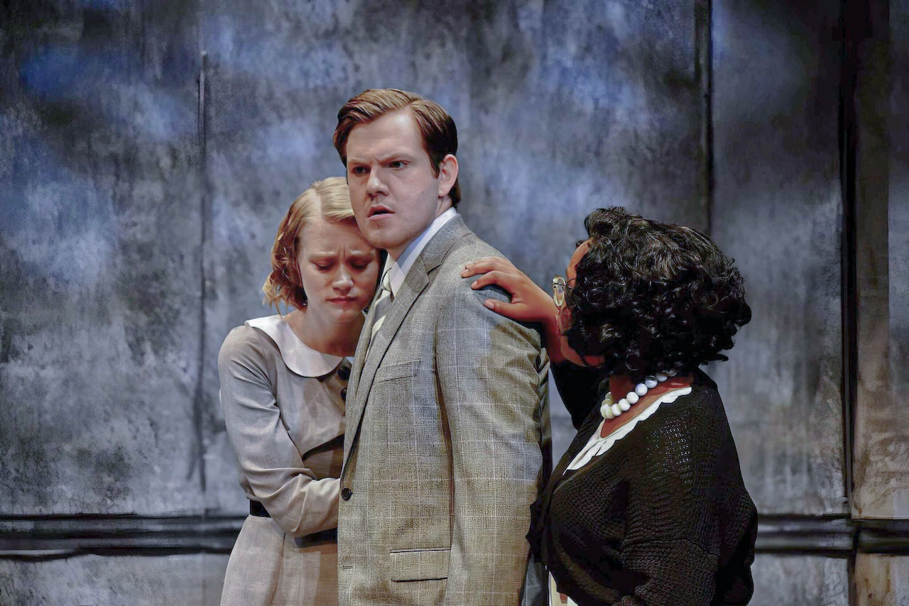 Scene from An Enemy of the People framed by the illustrated architecture, scenic design by Brandon PT Davis.