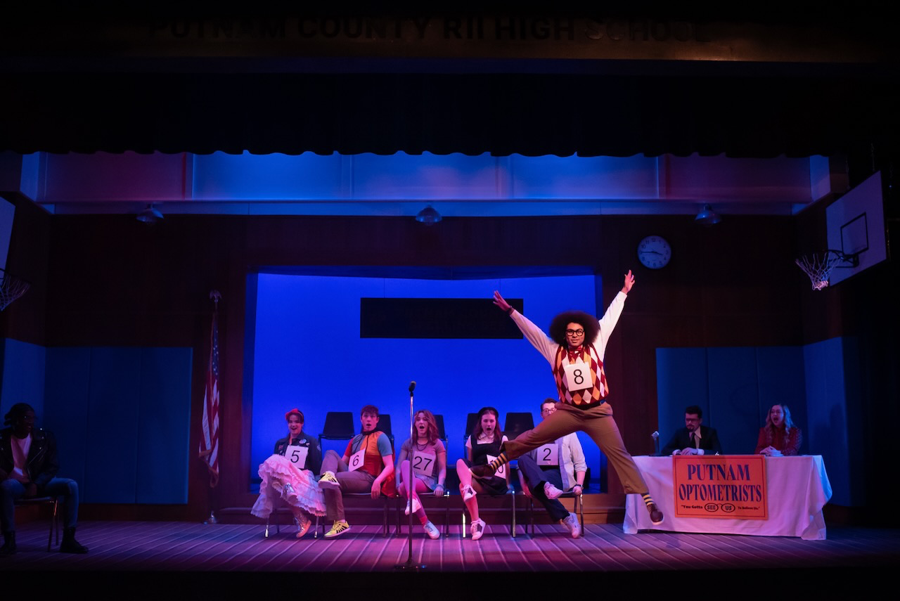 Putnam County Spelling Bee production image highlighting the local sponsor details and gym setting, scenic design by Brandon PT Davis.