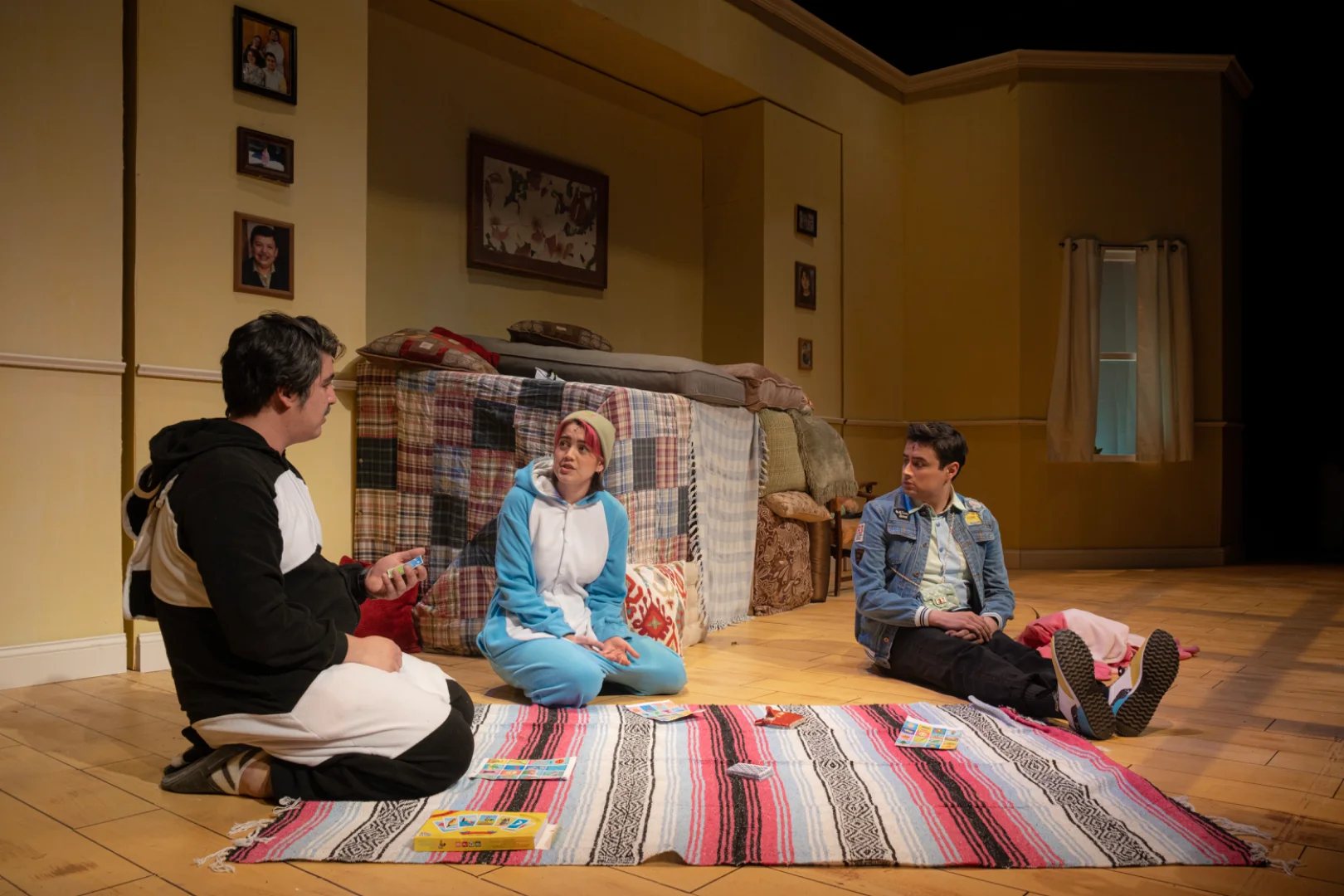 Production image from ¡LOTERIA: GAME ON! showing the basement family-room world, scenic design by Brandon PT Davis.