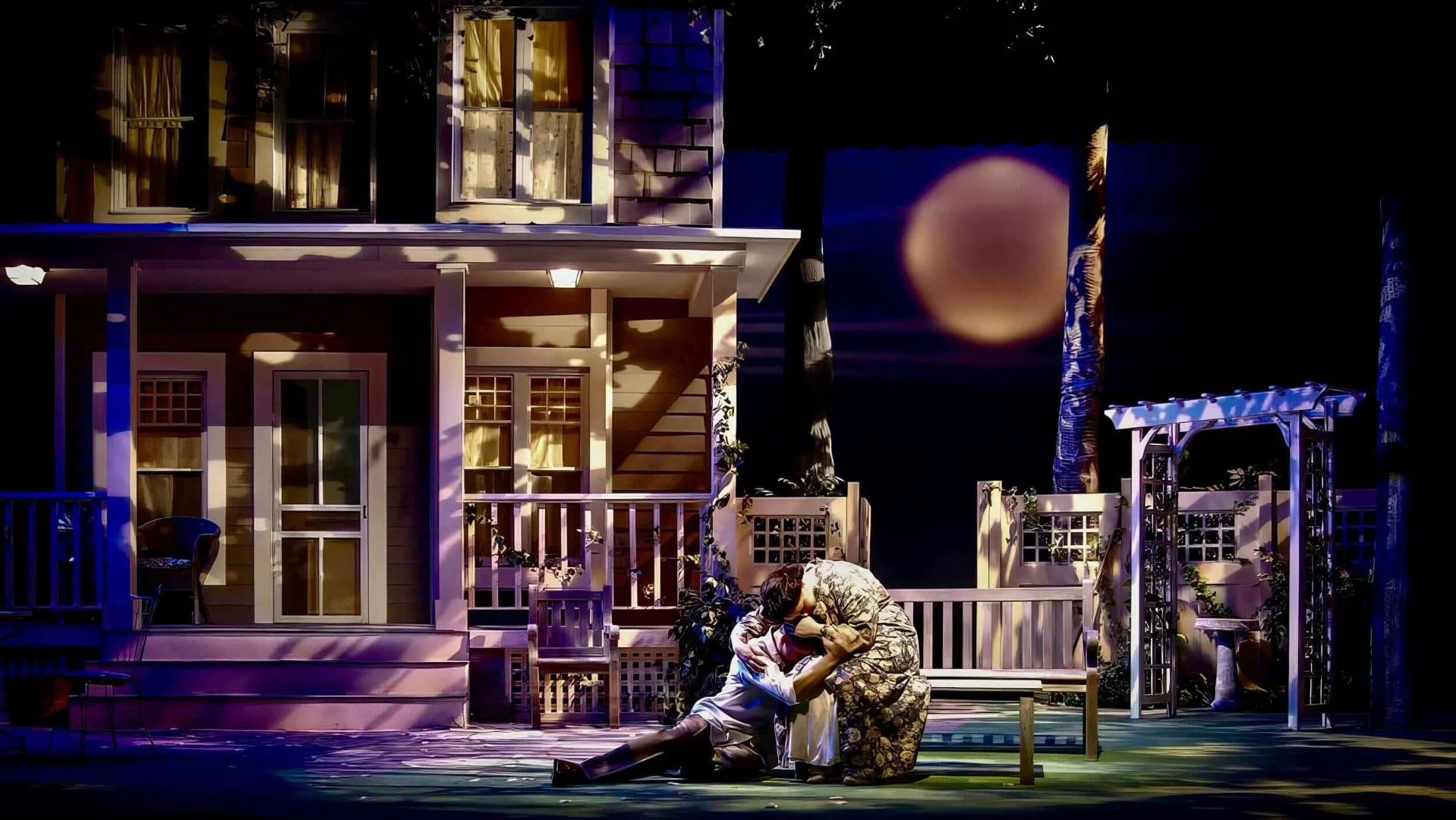 Production image from All My Sons showing how the open setting exposes private conflict, scenic design by Brandon PT Davis.