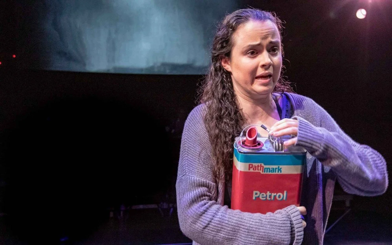 Performance image from Parliament Square showing the stone circle as a container for protest, scenic design by Brandon PT Davis.