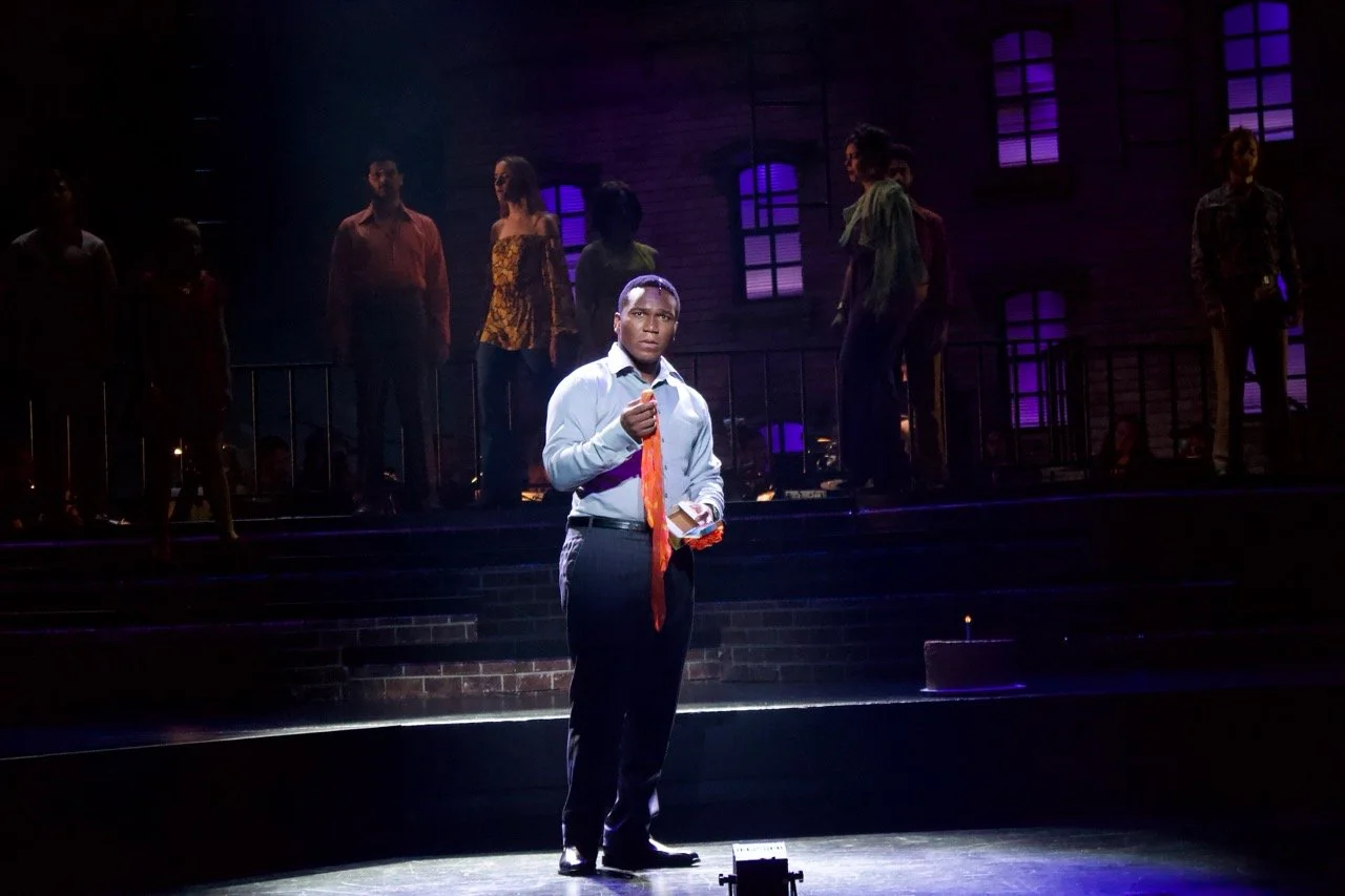 Production image from Company showing the coupled buildings and urban scenic composition, scenic design by Brandon PT Davis.