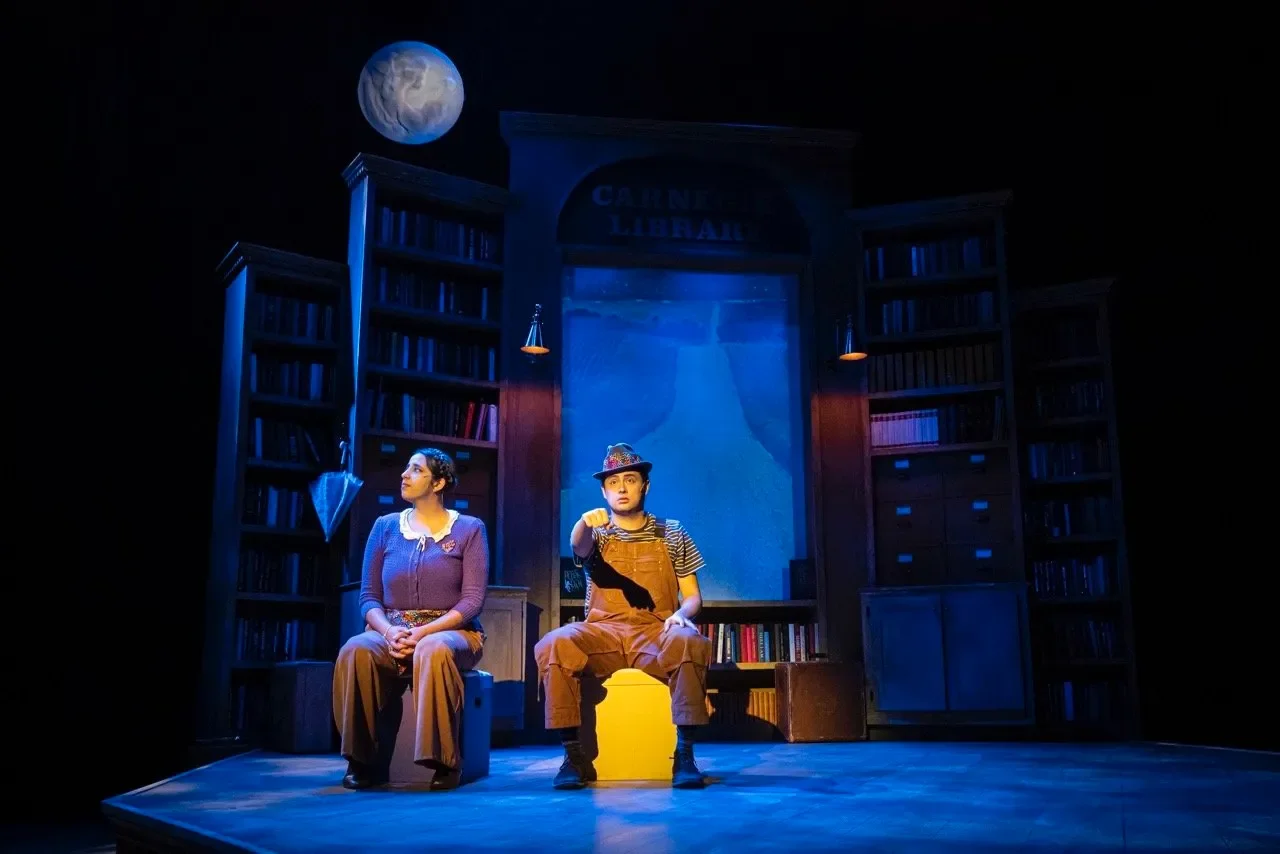 Production image from Tomás and the Library Lady with performers framed by the scenic architecture, scenic design by Brandon PT Davis.