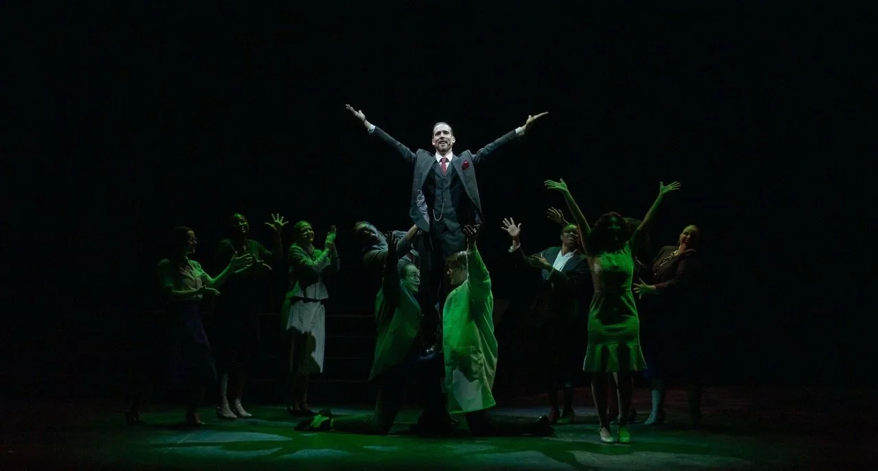 Onstage action framed by the urban architecture in Urinetown at Mizzou, scenic design by Brandon PT Davis.