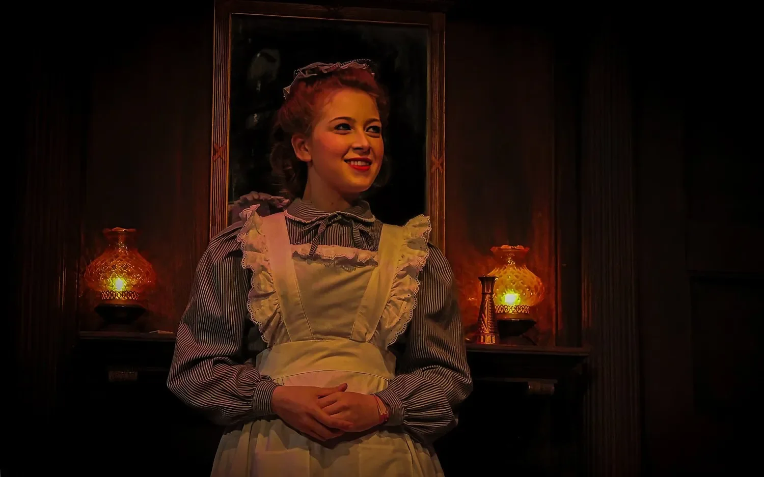 Production image from Angel Street highlighting wainscoting, staircase, and enclosed domestic atmosphere, scenic design by Brandon PT Davis.