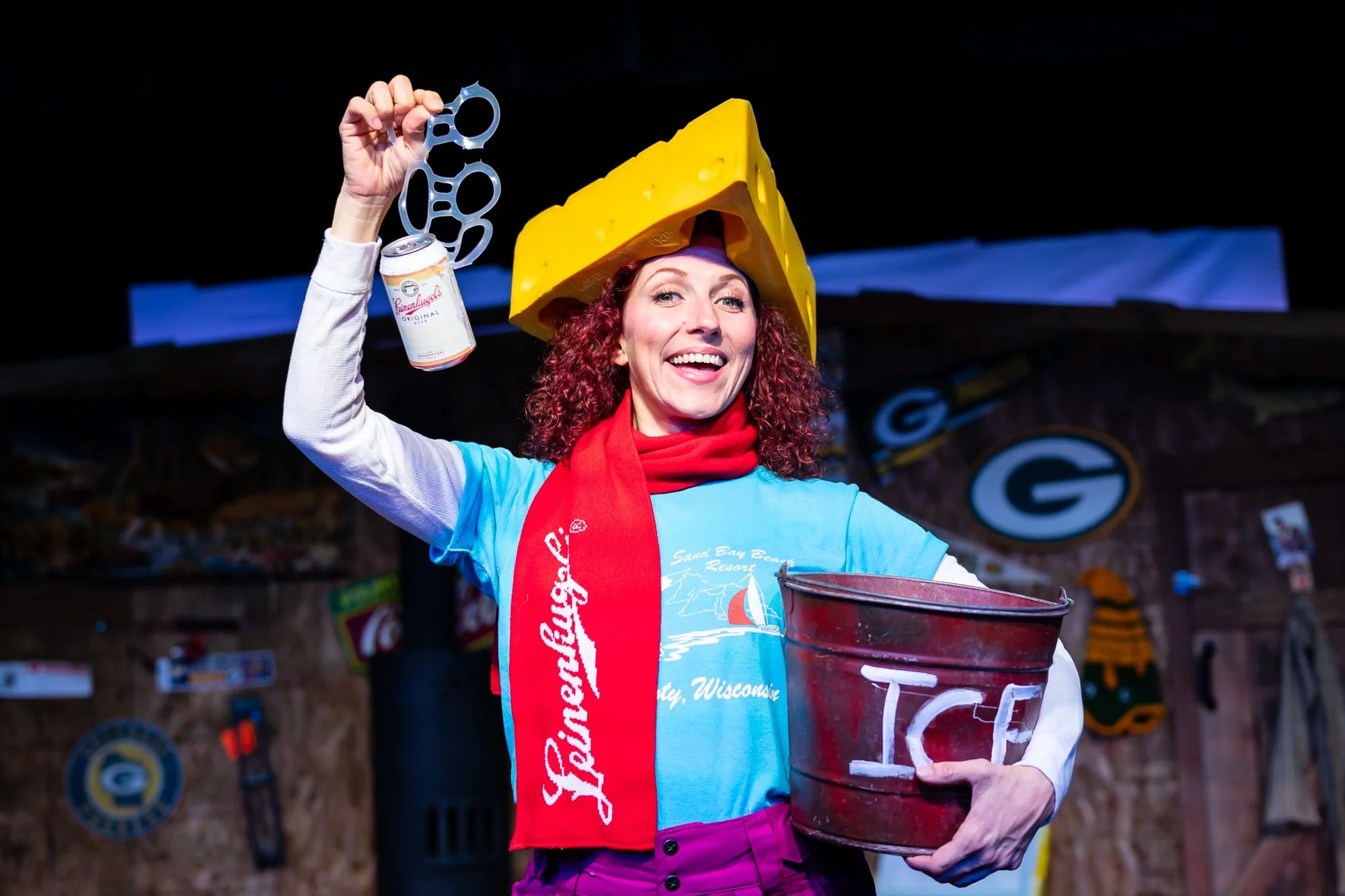 Performance moment across the central scenic playing area in Guys on Ice, scenic design by Brandon PT Davis.