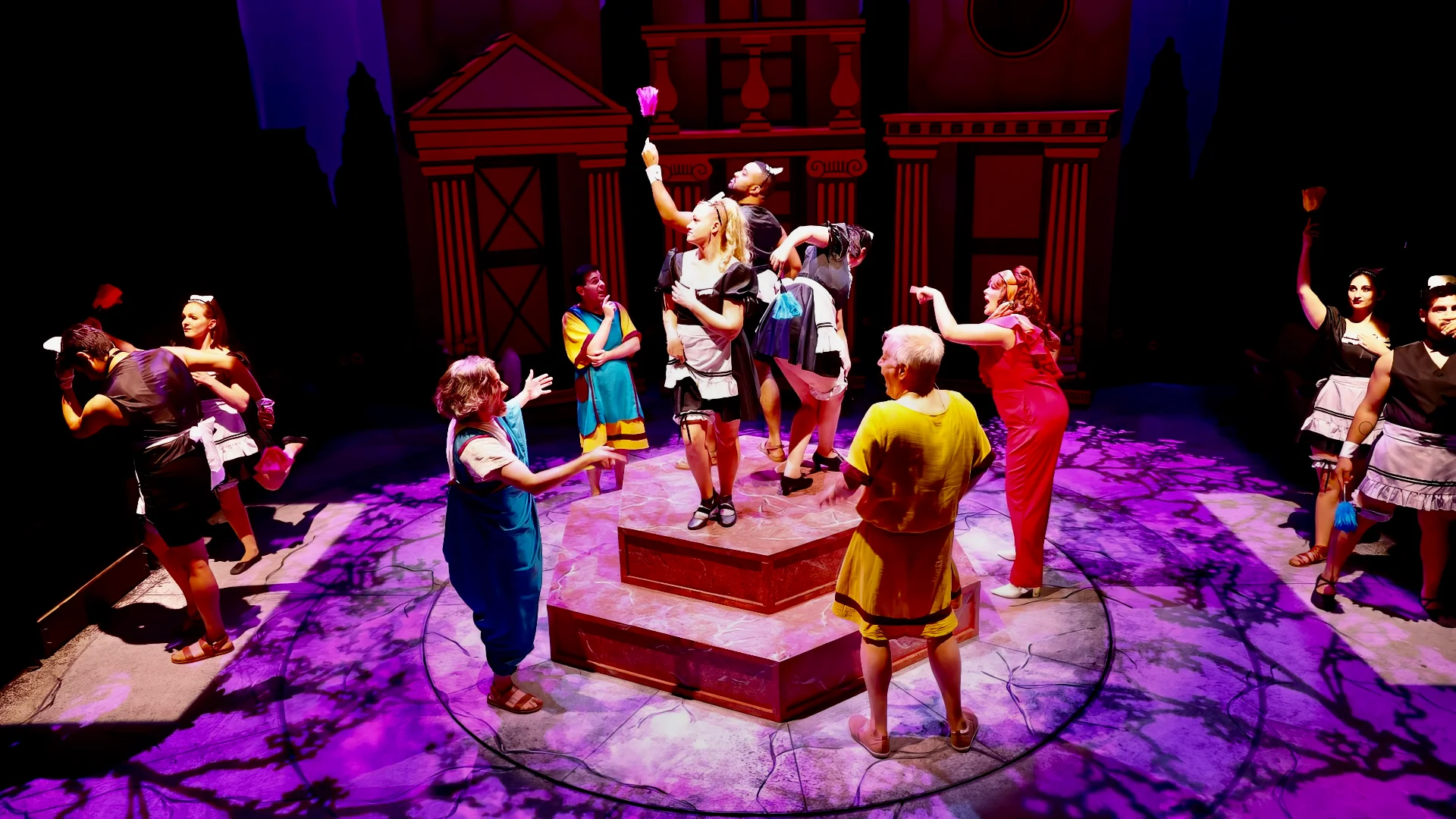 Performance image from Forum with actors moving through the farce-driven Roman architecture, scenic design by Brandon PT Davis.