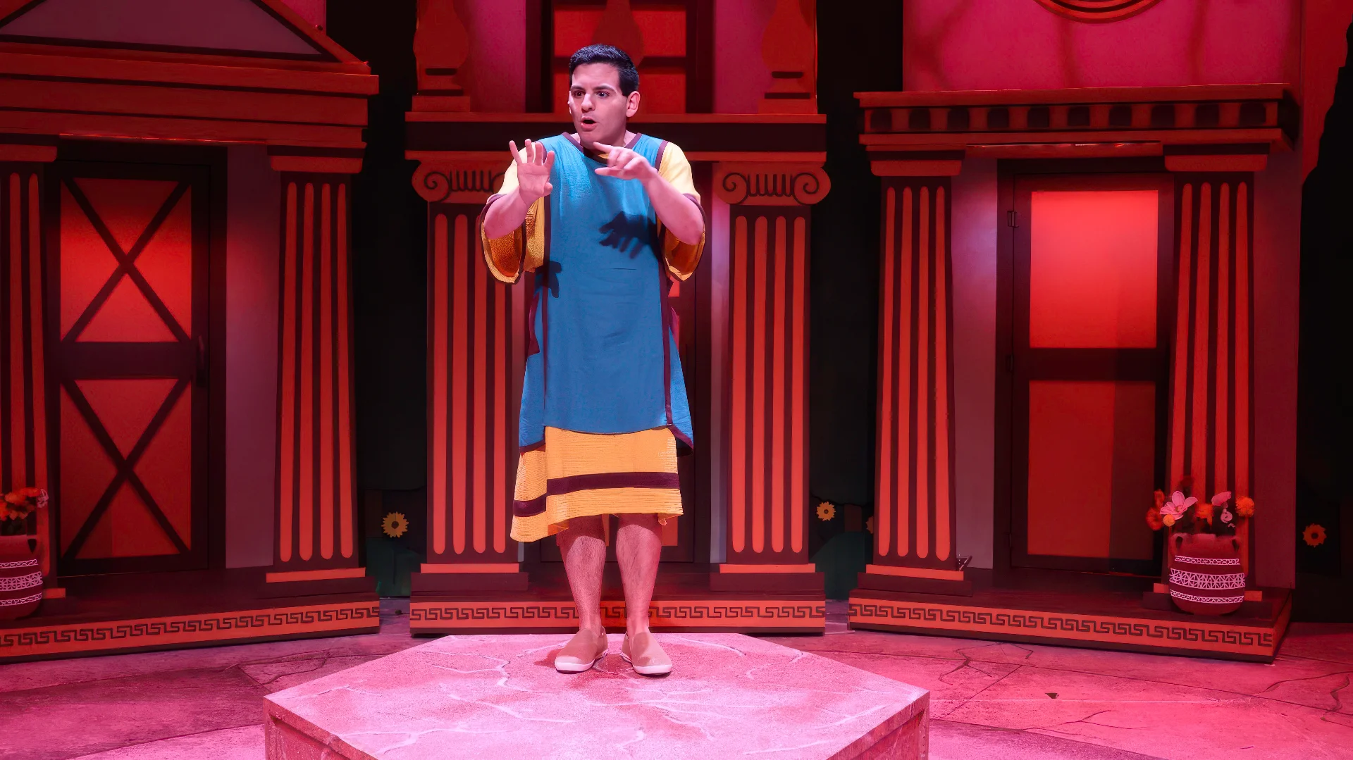 Production still from Forum highlighting the exaggerated façades and playful classical motifs, scenic design by Brandon PT Davis.