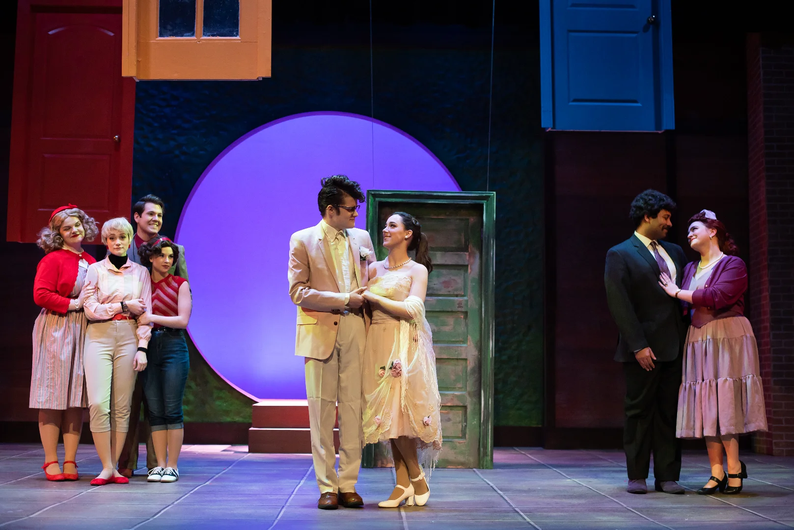Stage image from The Merry Wives of Windsor showing architectural framing and ensemble action, scenic design by Brandon PT Davis.