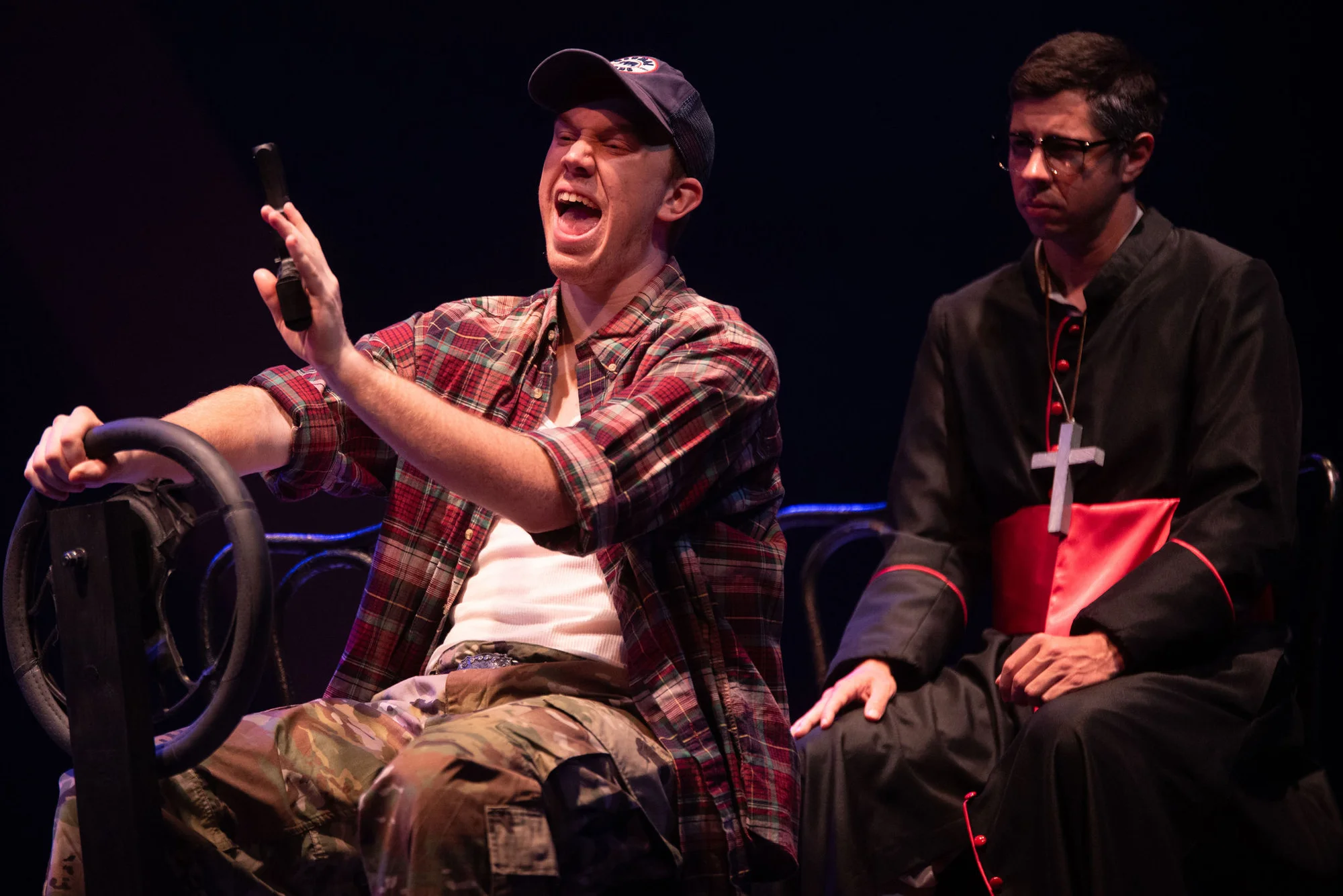 Actors positioned within the architectural and symbolic scenic world of Romero, scenic design by Brandon PT Davis.